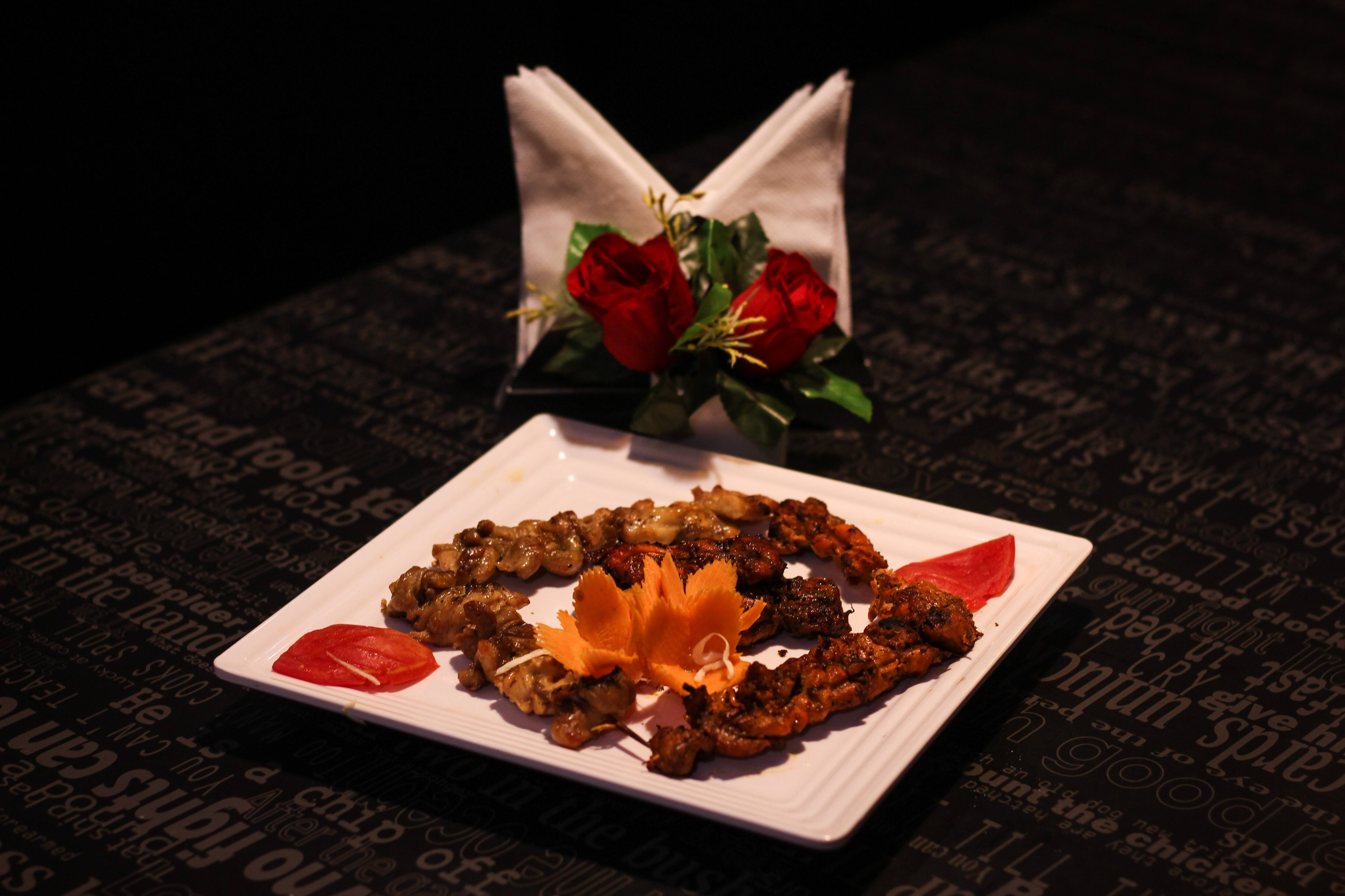 Grilled kebabs on a restaurant table at Mandi@36