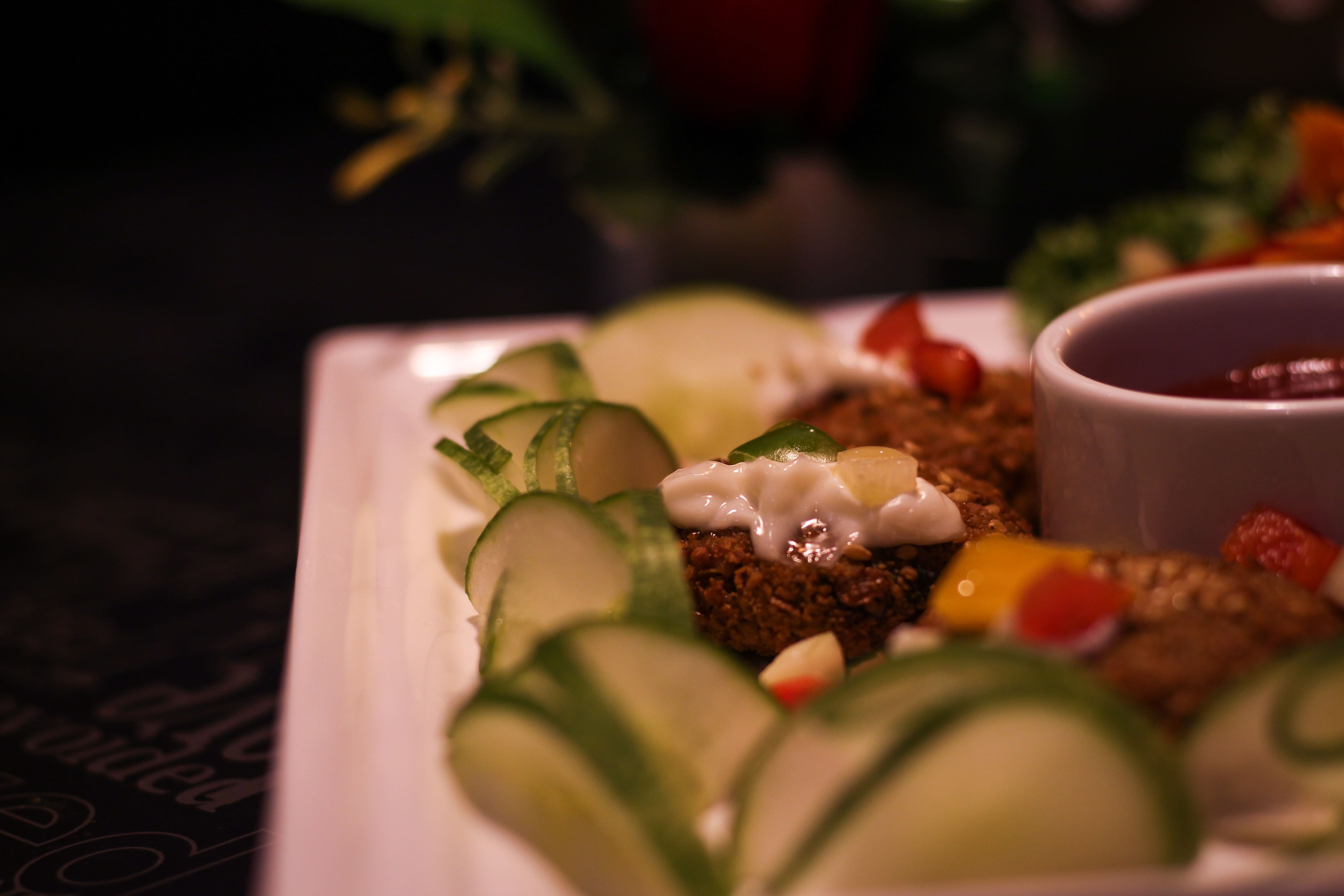 Plated kebabs with cucumber and dip at Mandi@36